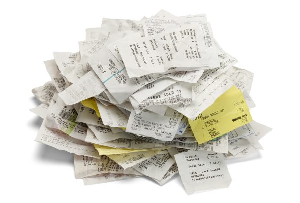 Shoebox overflowing with crumpled receipts